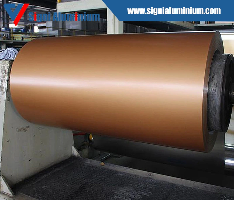 A copper-toned anodised coil mounted on a production winder