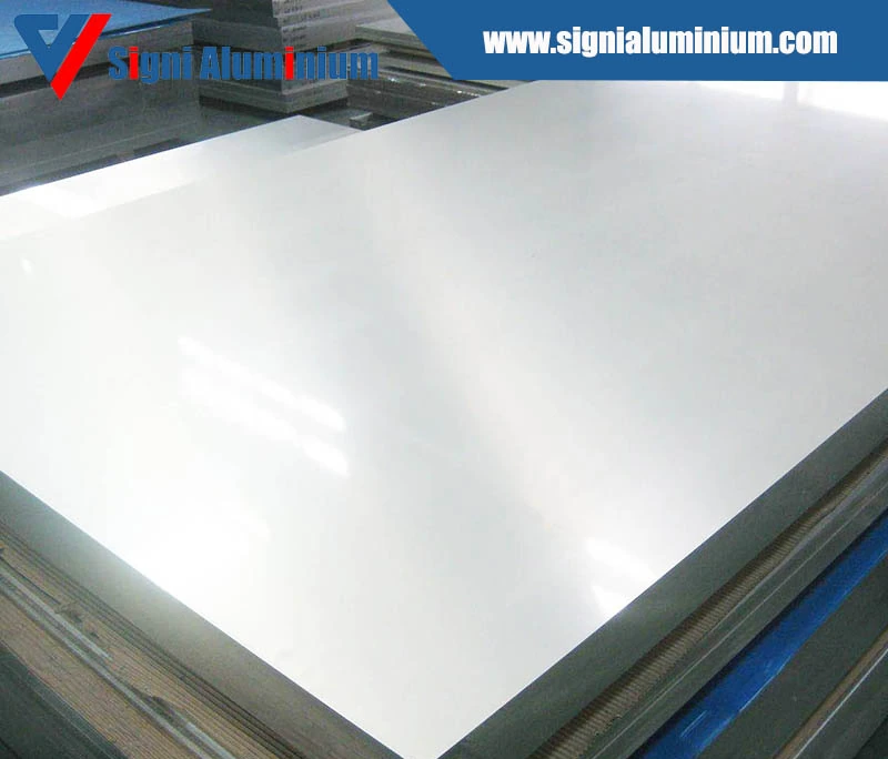 A stack of bright aluminium clad sheets on a wooden pallet