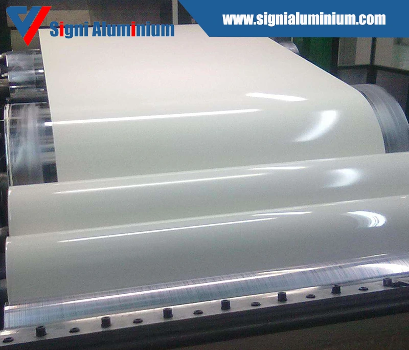 A wide white coated sheet coming off a coating line roll