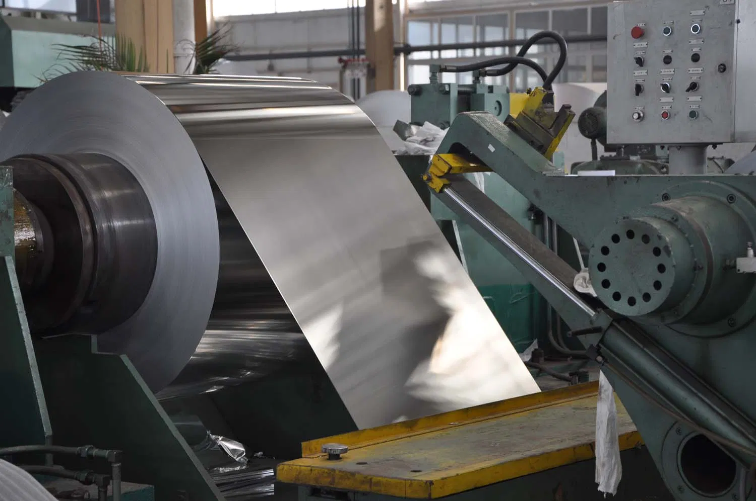 A wide aluminium coil unwinding on a production line