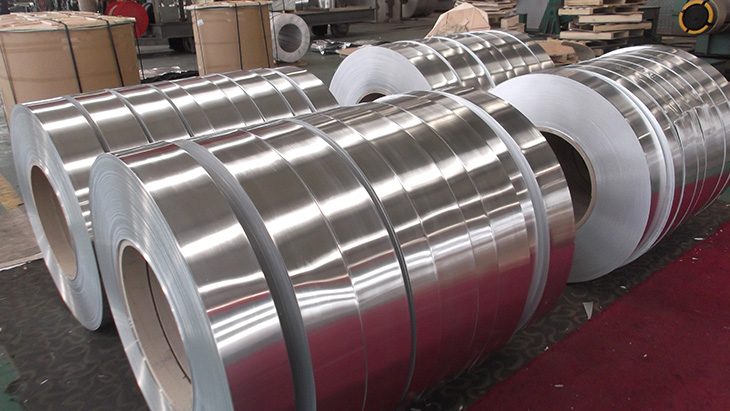 Wide aluminium mother coils with bright mill finish in a warehouse