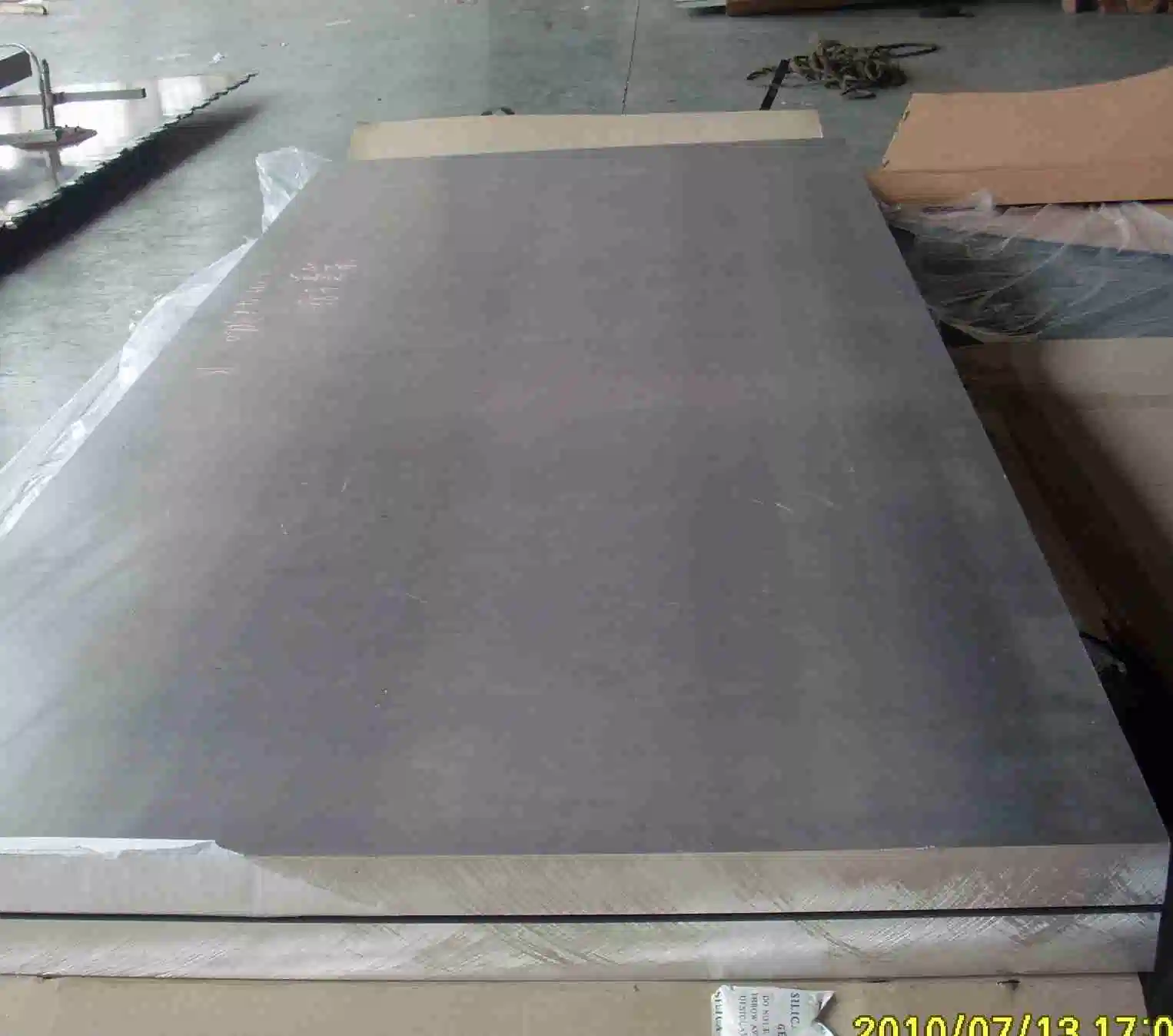 A stack of thick aluminium plates with a matte surface