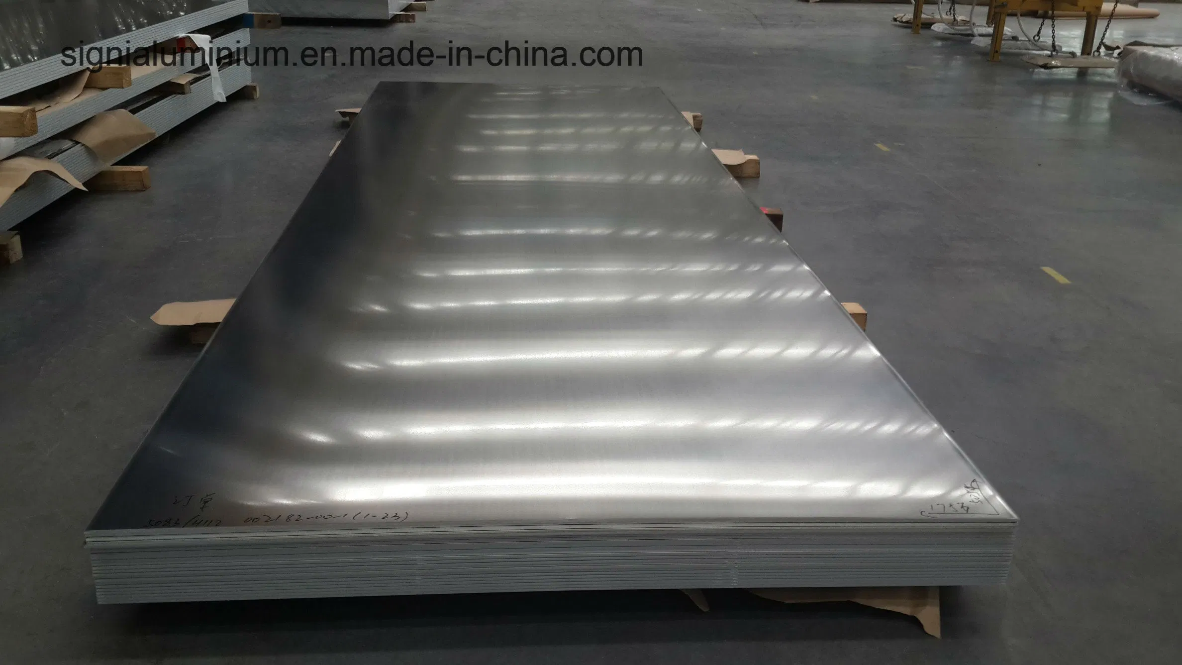 A stack of wide aluminium plates with 5083/H112 markings visible on the top sheet