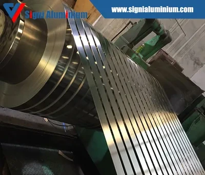 A coil being slit into multiple narrow strips on a slitting line